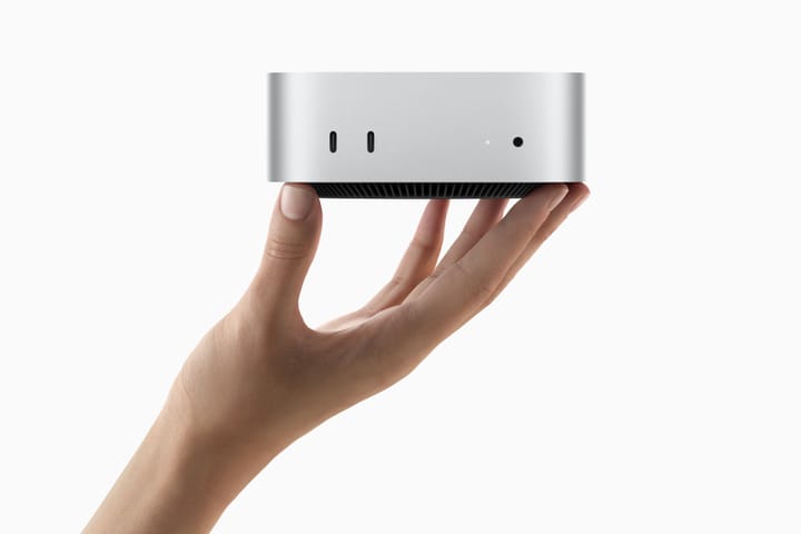 Apple image of a hand holding up the new Mac mini